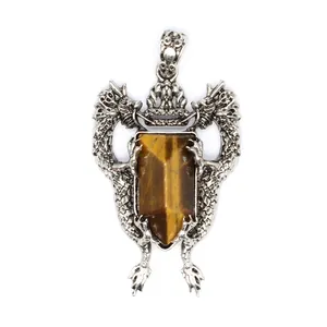 Detailed view of vintage silver double dragon shield pendant with tiger's eye stone