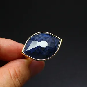Detail view of faceted blue stone Eye of Horus ring with gold plating