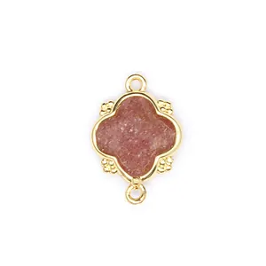 Close-up of a gold-plated quatrefoil charm with natural pink stone for DIY jewelry