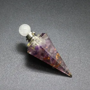 Detailed view of a hexagonal conical resin pendant with natural tourmaline stone chips