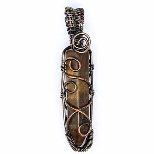 Close-up detail of wire-wrapped natural tiger eye stone hexagonal pillar pendant