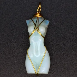 Vista macro dettagliata di un colgante de torso femenino de opalita con alambre dorado fino