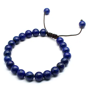 Close-up of 8mm blue natural stone beads on a hand-braided adjustable cord bracelet.