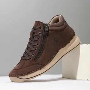 Close-up of a brown hand-stitched casual shoe with side zipper and tan sole.