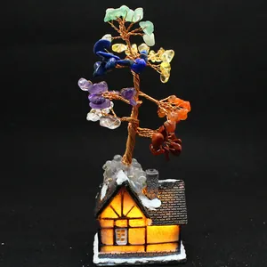 Detailed view of handmade seven chakra crystal tree on a glowing house base