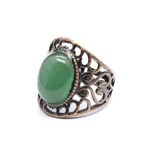 Vintage bronze open ring featuring an oval green natural stone and intricate hollow pattern