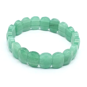 Macro view of a green natural stone faceted bracelet showing polished rectangular bead texture.
