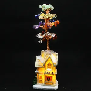 Detailed view of handmade chakra crystal tree with glowing LED cafe house base