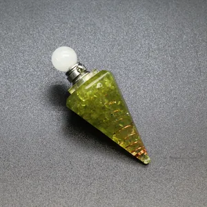 Macro detail of hexagonal resin pyramid pendant with peridot stones and copper coil