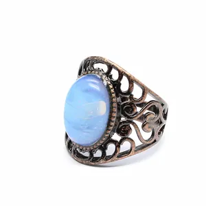 Close-up of a vintage hollow-out ring with a blue agate stone in antique finish