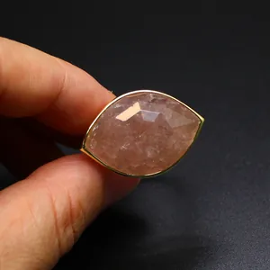 Macro view of marquise faceted strawberry quartz crystal ring with gold plated setting