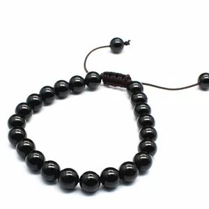 Detailed view of 8mm polished black onyx stone bead adjustable braided bracelet