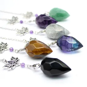 Macro detail view of assorted natural stone faceted cone pendants with lotus flower charms.