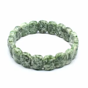 Close-up of green mottled natural stone rectangle bead bracelet on white background