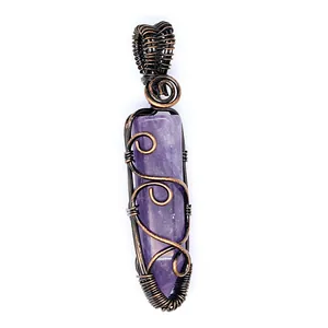 Detailed view of handmade copper wire wrapped purple amethyst hexagonal pillar pendant