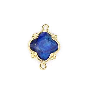 Macro view of blue faceted natural stone pendant with 18K gold plated clover frame
