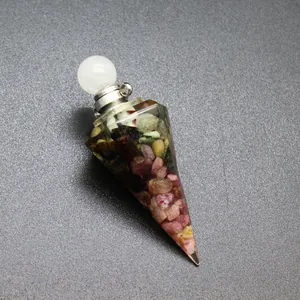 Close-up of hexagonal resin cone filled with colorful tourmaline stones and white cap.