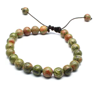 Detail of 8mm unakite stone beads on a handmade woven adjustable bracelet.