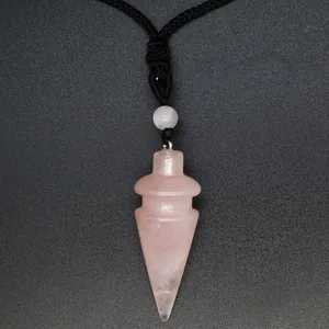 Detail view of a rose quartz cone-shaped crystal pendant on a black braided cord necklace