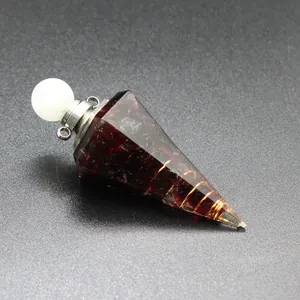 Close-up of hexagonal resin crystal cone with tourmaline chips and copper wire.