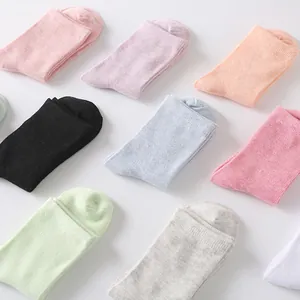 Assorted pastel candy colored cotton mid-calf socks for women in a clean grid layout