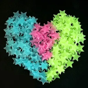 Colorful 3D glow-in-the-dark star wall stickers arranged in a heart shape on black background