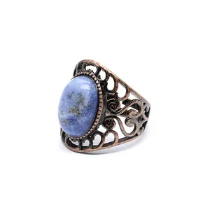 Detail showing the intricate hollow patterns and blue agate stone of this vintage ring.