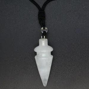 Close-up detail of a white conical crystal pendant with a black cord necklace