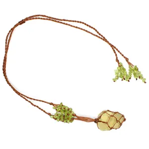 Close-up of green fluorite raw stone necklace in brown woven net with peridot accents