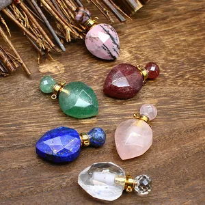 Faceted natural stone perfume bottle pendants in multiple crystal materials on wood