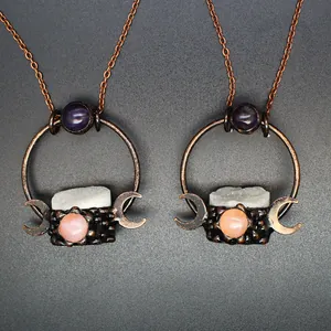 Detailed view of medieval vintage style necklaces with moon pendants and gemstones.