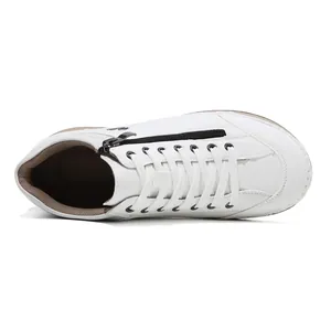 Top view of white hand-stitched women's casual flat shoes with side zipper detail