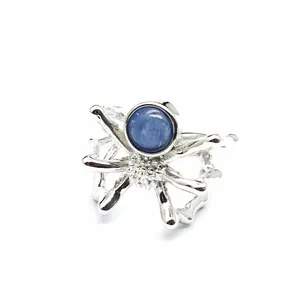 Detailed close-up of a silver spider open ring featuring a round blue kyanite stone