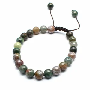Detailed macro view of 8mm natural moss agate beads on an adjustable brown cord