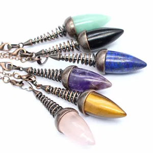 Close-up of assorted crystal bulb pendulums with vintage copper spiral details