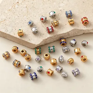 Detailed macro view of stainless steel beads with colorful cubic zirconia for jewelry.