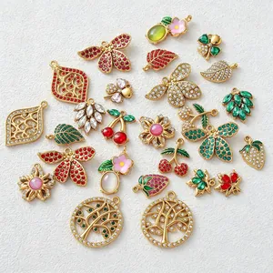 Assorted stainless steel gold-plated charms with zircon, featuring flower and fruit shapes.