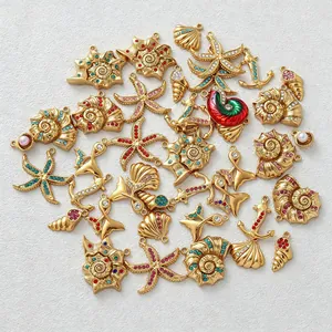 Close-up of gold-plated ocean-themed charms with colorful rhinestones for DIY jewelry