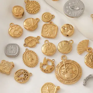 Detailed macro view of mixed 18K gold plated stainless steel jewelry charms and pendants