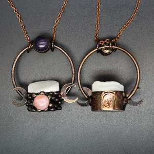 Close-up detail of gothic medieval style copper pendant necklaces with raw white crystal