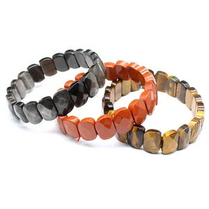 Macro detail of faceted natural gemstone stretch bracelets featuring tiger eye and red jasper