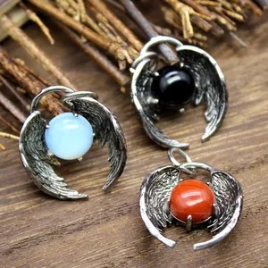 Detailed view of angel wing pendants with various colored natural stone beads.