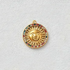 Dettaglio di un ciondolo a sole in acciaio inossidabile dorato con zirconi multicolore