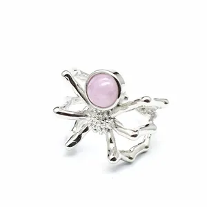 Unique spider-shaped silver ring featuring a smooth round pink kunzite gemstone detail.