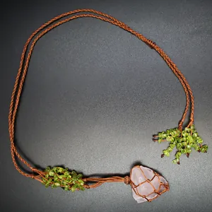 Macro detail of Bohemian braided necklace with raw rose quartz and peridot stone chips