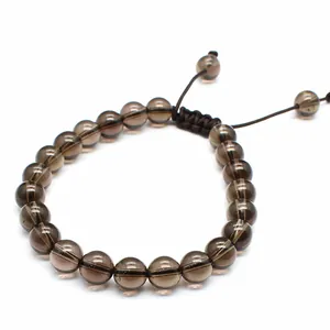 Detailed view of 8mm smoky brown natural stone beads on a hand-woven bracelet