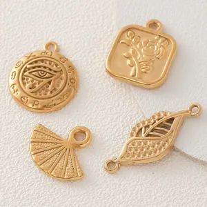 Detailed view of four gold-plated stainless steel charms for DIY jewelry making accessories