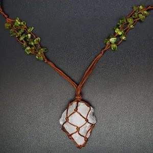 Detail view of a bohemian woven necklace with raw crystal pendant and peridot stone chips