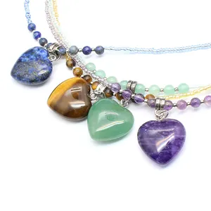 Detailed view of natural stone heart pendants in Amethyst, Tiger's Eye, and Aventurine