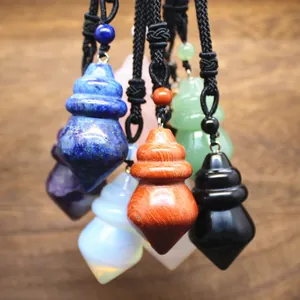 Macro detail showing a variety of colorful natural gemstone conical pendants with black cords